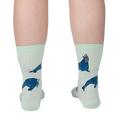 Lifestyle shot showing the socks on a person's legs from the back, showcasing the full design of the socks.
