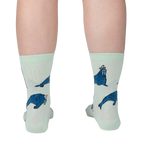 Lifestyle shot showing the socks on a person's legs from the back, showcasing the full design of the socks.