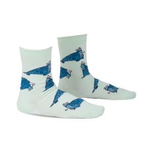 Pair of mint green crew socks featuring a repeating pattern of cartoon walruses wearing sombreros.  The socks have a playful design and blue walrus accents.