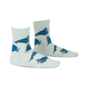 Pair of mint green crew socks featuring a repeating pattern of cartoon walruses wearing sombreros.  The socks have a playful design and blue walrus accents.
