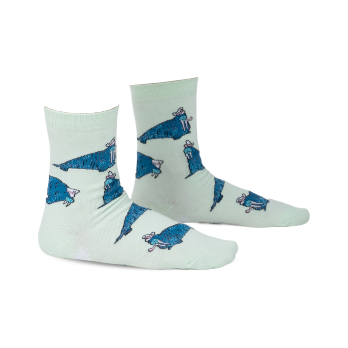 Pair of mint green crew socks featuring a repeating pattern of cartoon walruses wearing sombreros.  The socks have a playful design and blue walrus accents.