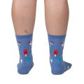 Back view of periwinkle blue crew socks with ice cream pattern on a person's legs.