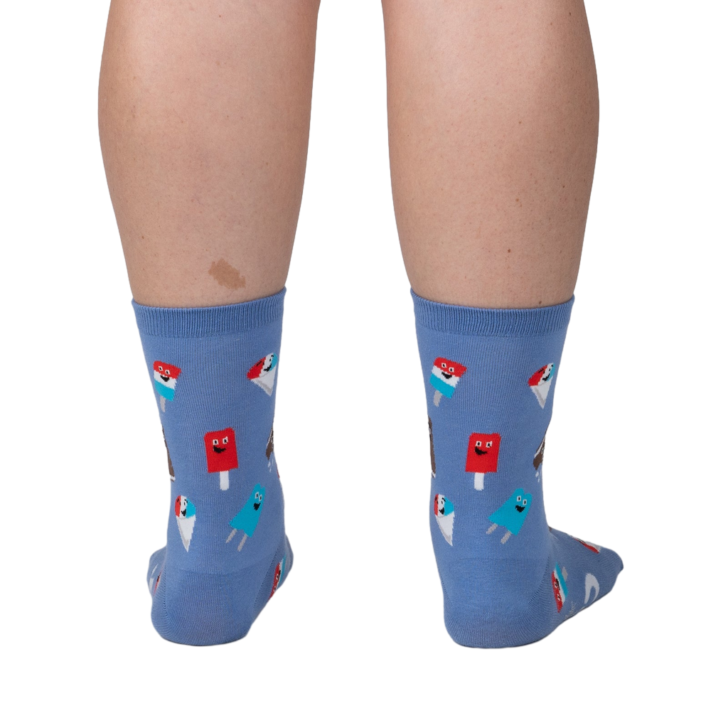 Back view of periwinkle blue crew socks with ice cream pattern on a person's legs.