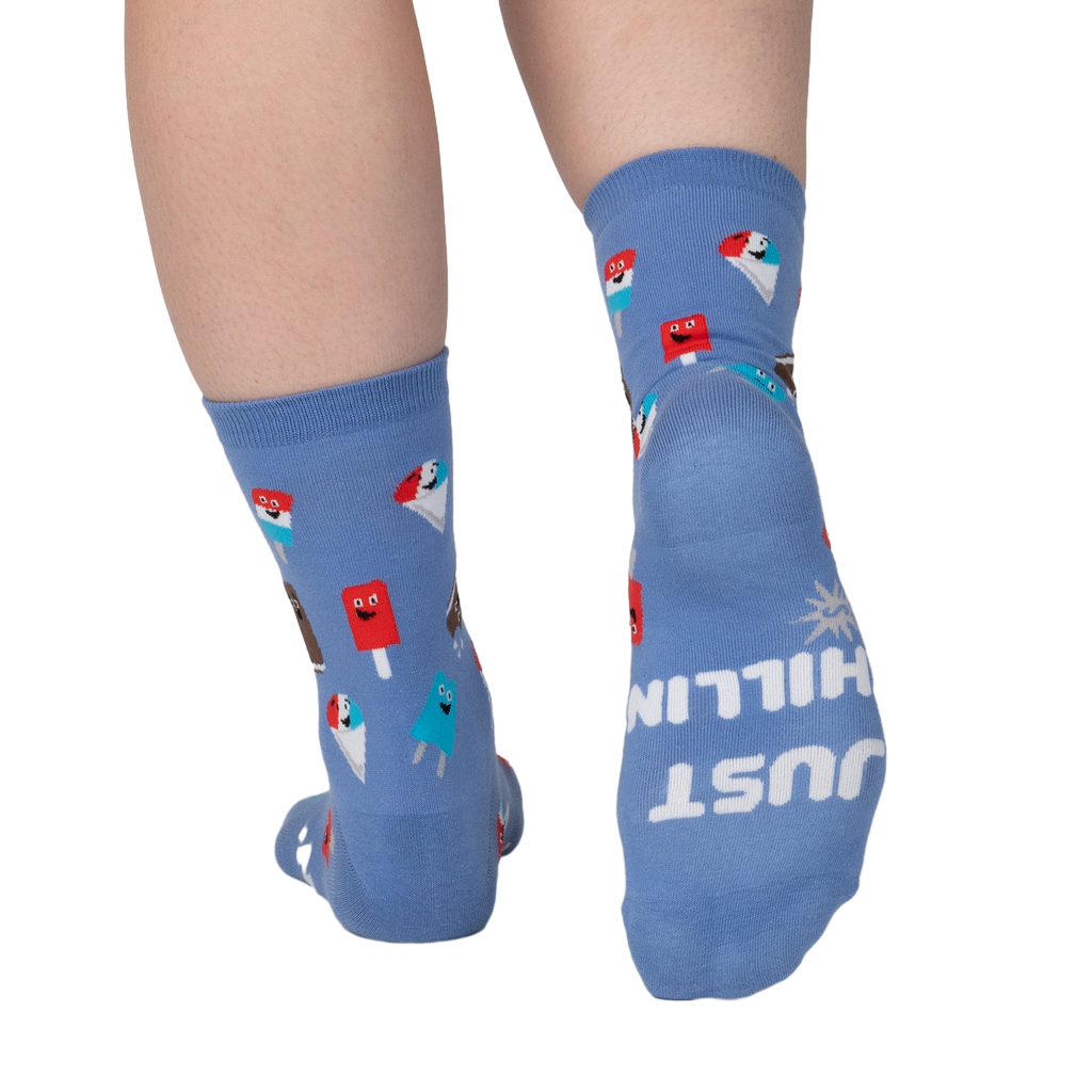 Rear view of periwinkle blue crew socks; the words 'JUST CHILLIN' are spelled out on one heel.
