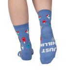 Rear view of periwinkle blue crew socks; the words 'JUST CHILLIN' are spelled out on one heel.