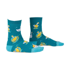 Pair of teal crew socks with a whimsical pattern of geese floating on inner tubes and swimming. Yellow and white geese on teal background.
