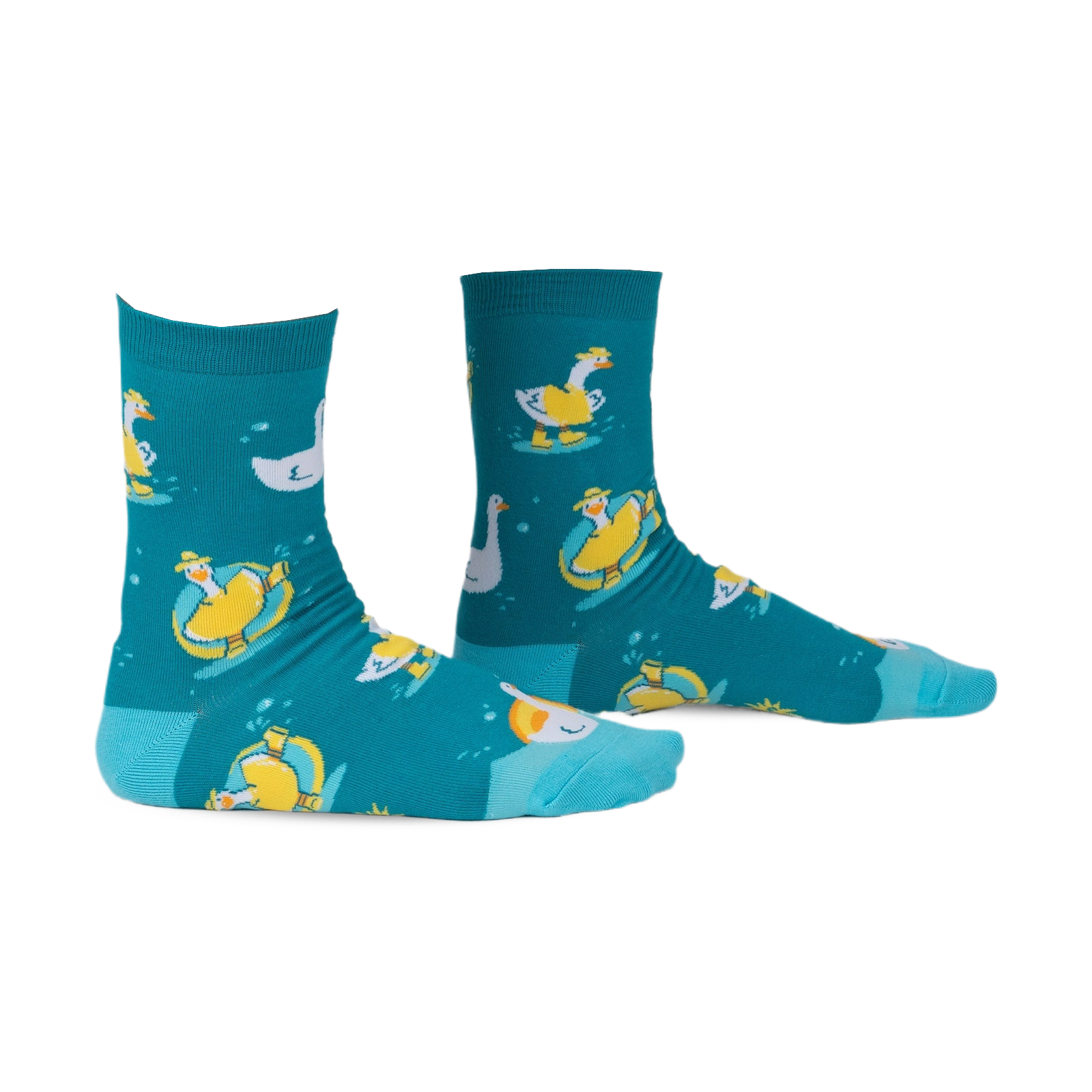 Pair of teal crew socks with a whimsical pattern of geese floating on inner tubes and swimming. Yellow and white geese on teal background.