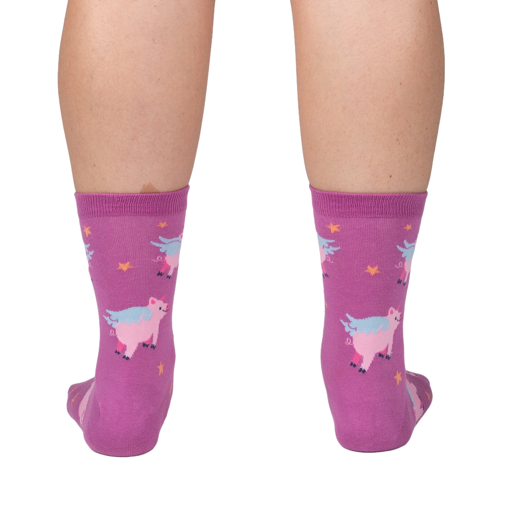 Lifestyle shot showing the 'When Pigs Fly' socks on a person's legs, showcasing the sock's fit and design.
