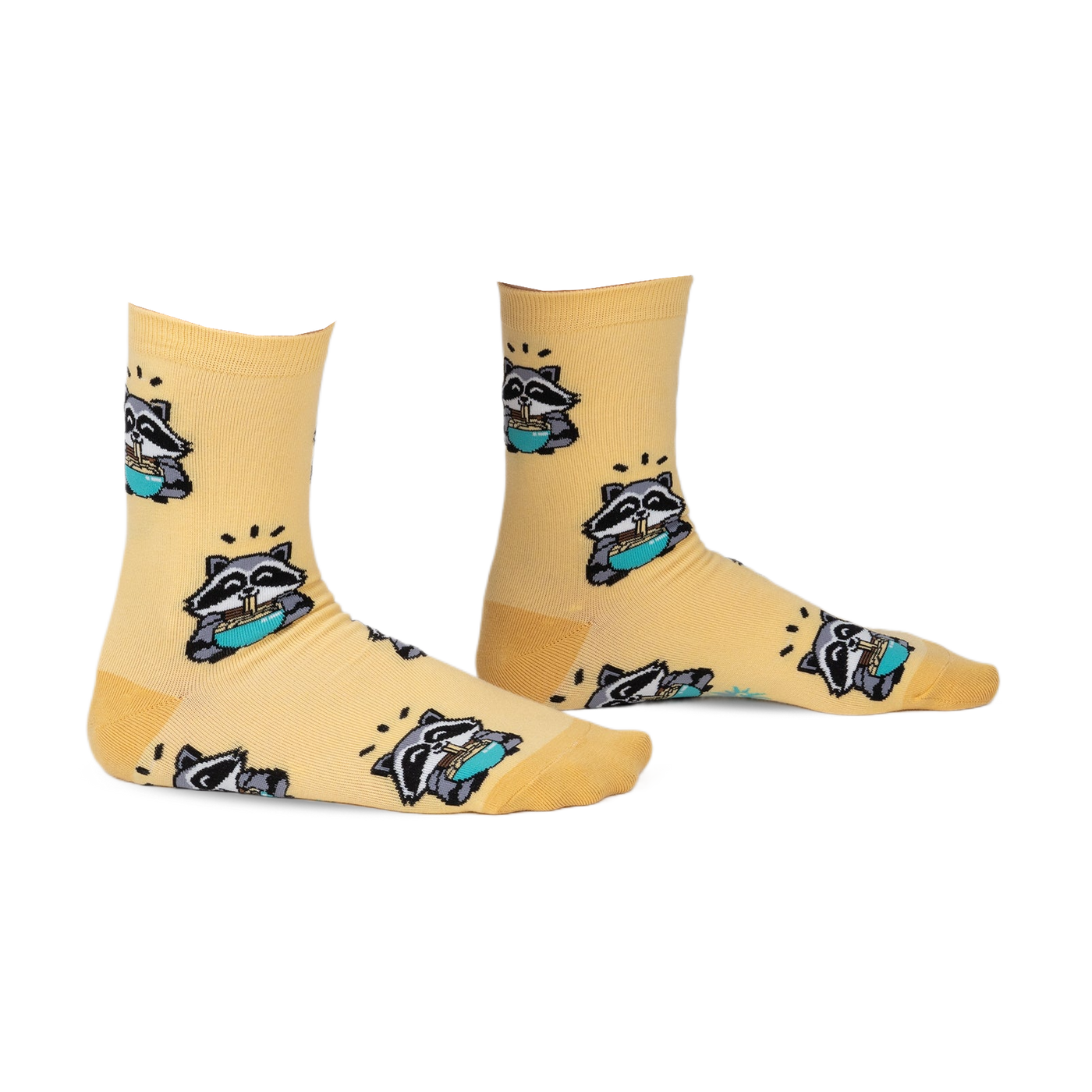 Pair of pastel yellow crew socks featuring a repeating pattern of raccoons enjoying ramen. 