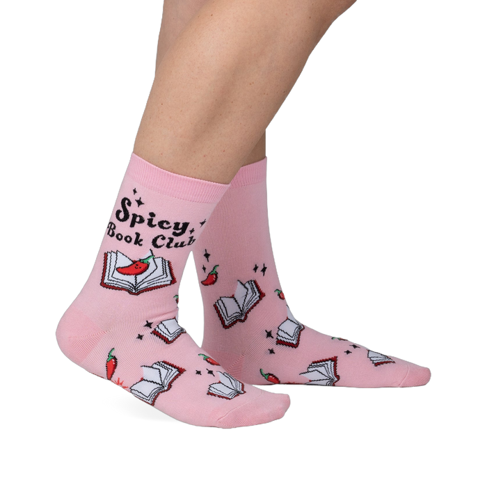 Pink crew socks with a playful design.  Features an illustration of books, chili peppers, and the text 