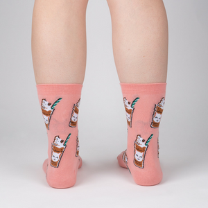 Back view of Cat-puccino socks on a person's legs, showcasing the full design on the socks against a light background.