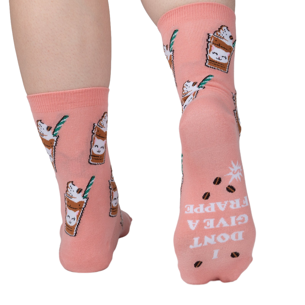 Close-up shot of the back of Cat-puccino socks. The socks have 'I DON'T GIVE A FRAPPE' text printed on the heel.