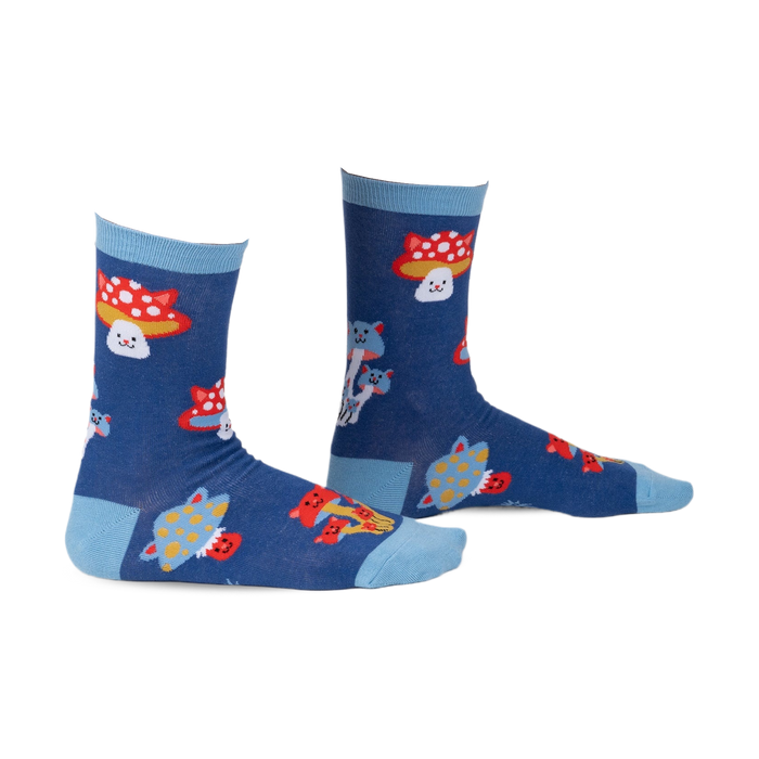 Pair of crew socks in navy blue with a whimsical design featuring cartoon cats and mushrooms in red, white, and yellow.