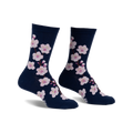 Pair of navy blue crew socks adorned with a pattern of pink cherry blossoms. 