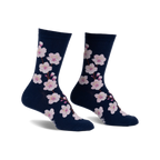 Pair of navy blue crew socks adorned with a pattern of pink cherry blossoms. 