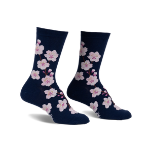 Pair of navy blue crew socks adorned with a pattern of pink cherry blossoms. 