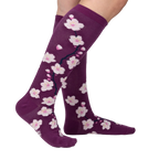 Lifestyle shot of Cherry Blossom socks on a woman's legs.