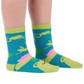 A person's legs and feet wearing the fuzzy teal blue slipper socks, shown from the side.