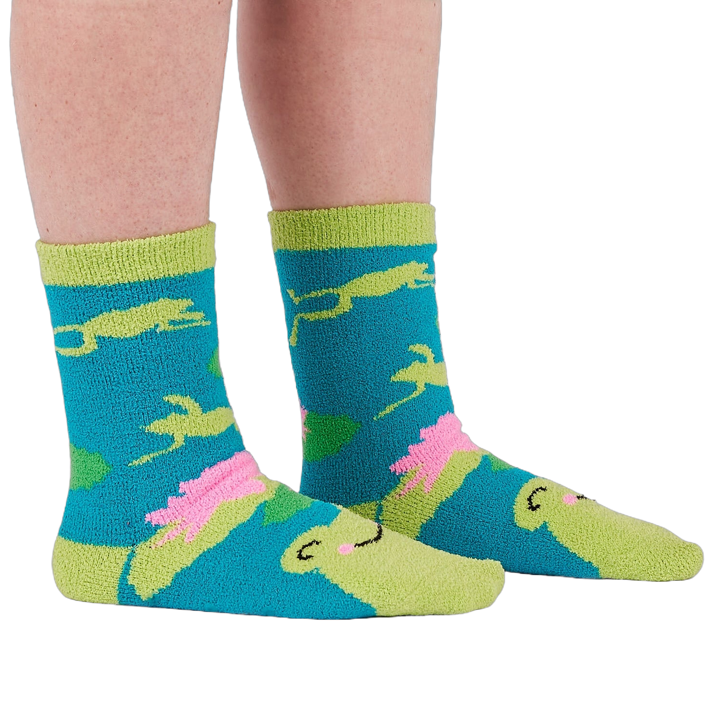 A person's legs and feet wearing the fuzzy teal blue slipper socks, shown from the side.