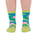 A person's legs and feet, viewed from the front, wearing the fuzzy teal blue slipper socks.