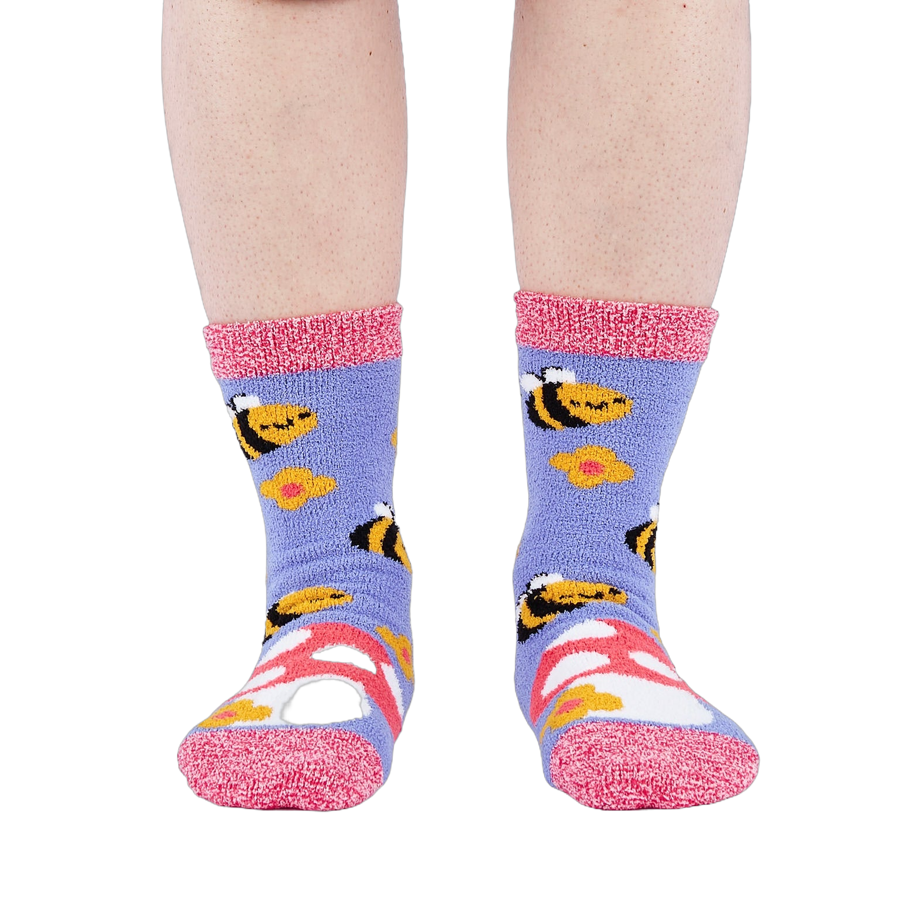 Person wearing fuzzy periwinkle slipper socks with bee, mushroom, and flower patterns, front view.