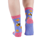 Person wearing fuzzy periwinkle slipper socks, back view, showing the anti-slip grippers on the sole.