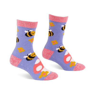 Pair of fuzzy periwinkle slipper socks with pink cuffs, heels, and toes, patterned with yellow bees, mushrooms, and flowers.
