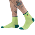 Lifestyle photo showing the Plant Lover socks on a person's feet.
