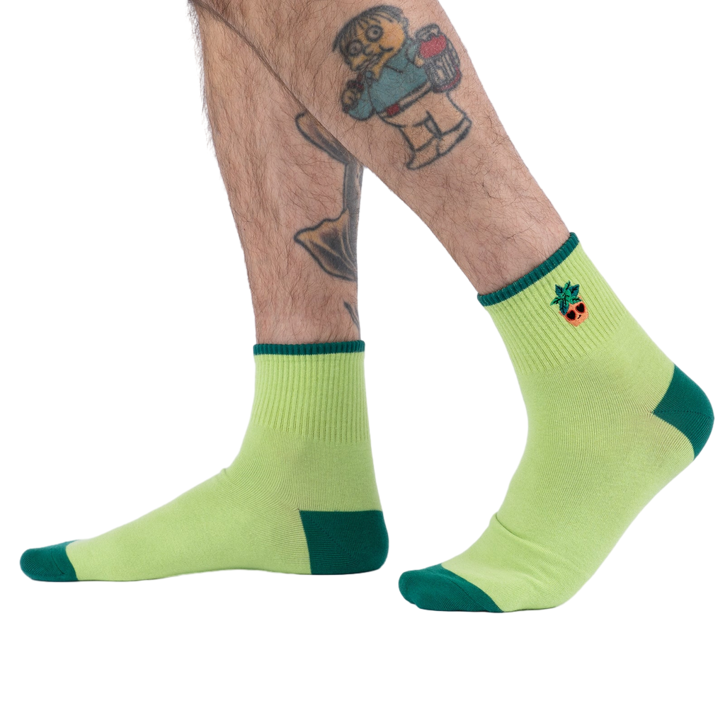 Lifestyle photo showing the Plant Lover socks on a person's feet.