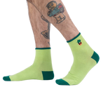 Lifestyle photo showing the Plant Lover socks on a person's feet.
