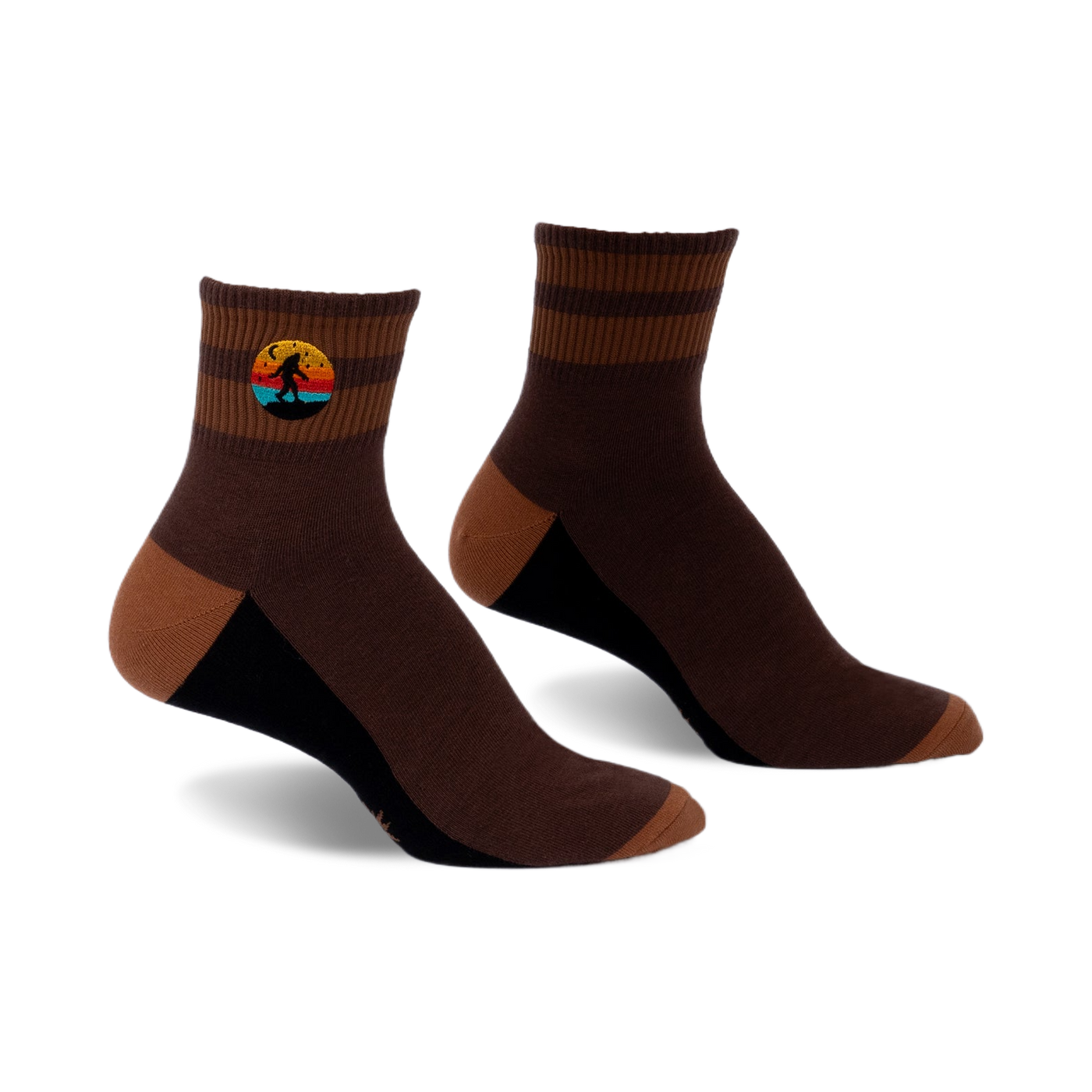 Pair of brown and tan striped ankle socks with a small embroidered Bigfoot in a retro sunset design.