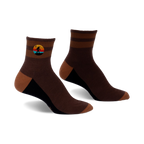 Pair of brown and tan striped ankle socks with a small embroidered Bigfoot in a retro sunset design.