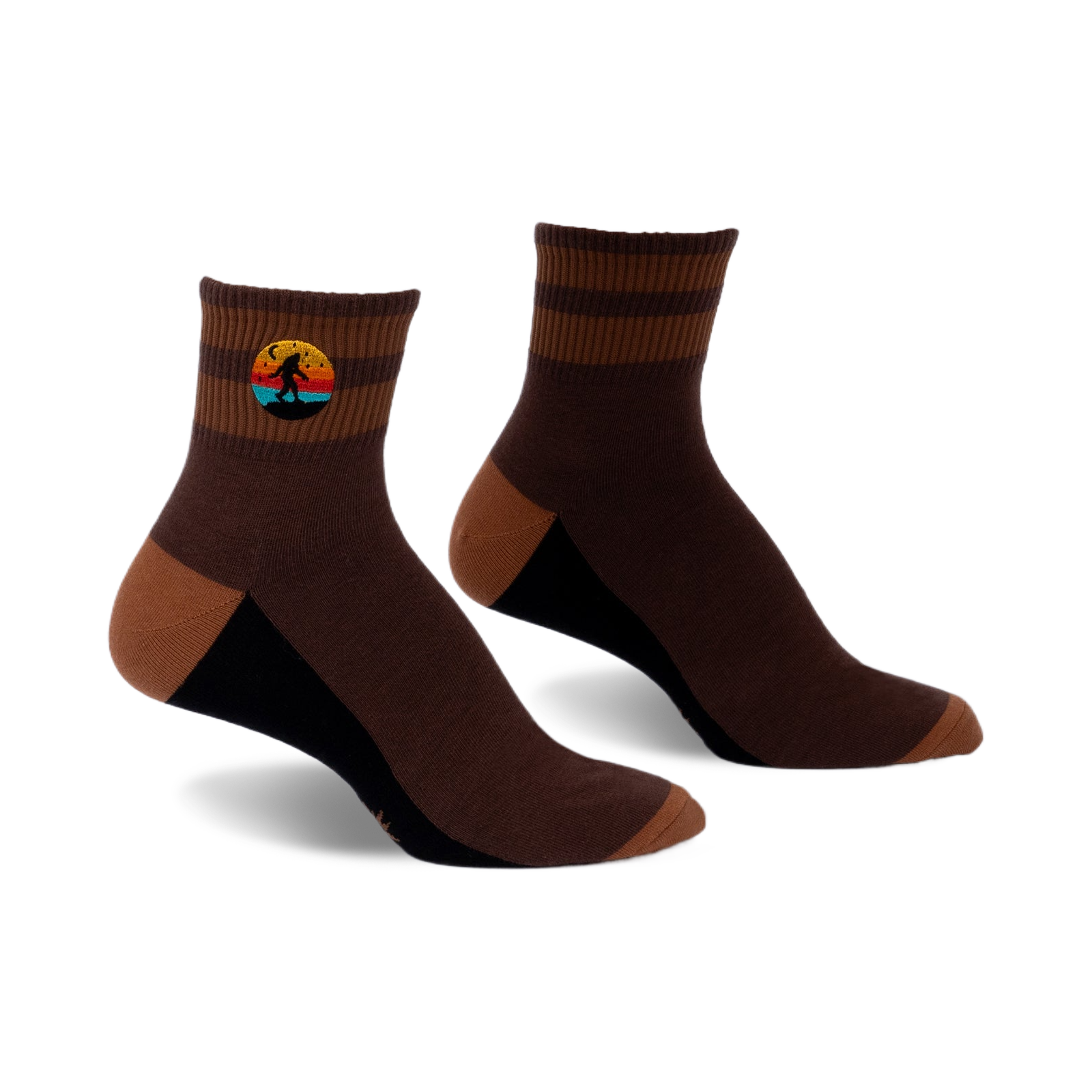Pair of brown and tan striped ankle socks with a small embroidered Bigfoot in a retro sunset design.