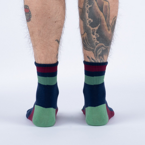 Back view of the socks, highlighting the color block design and striped cuffs.