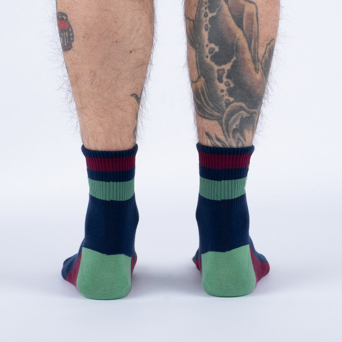 Back view of the socks, highlighting the color block design and striped cuffs.