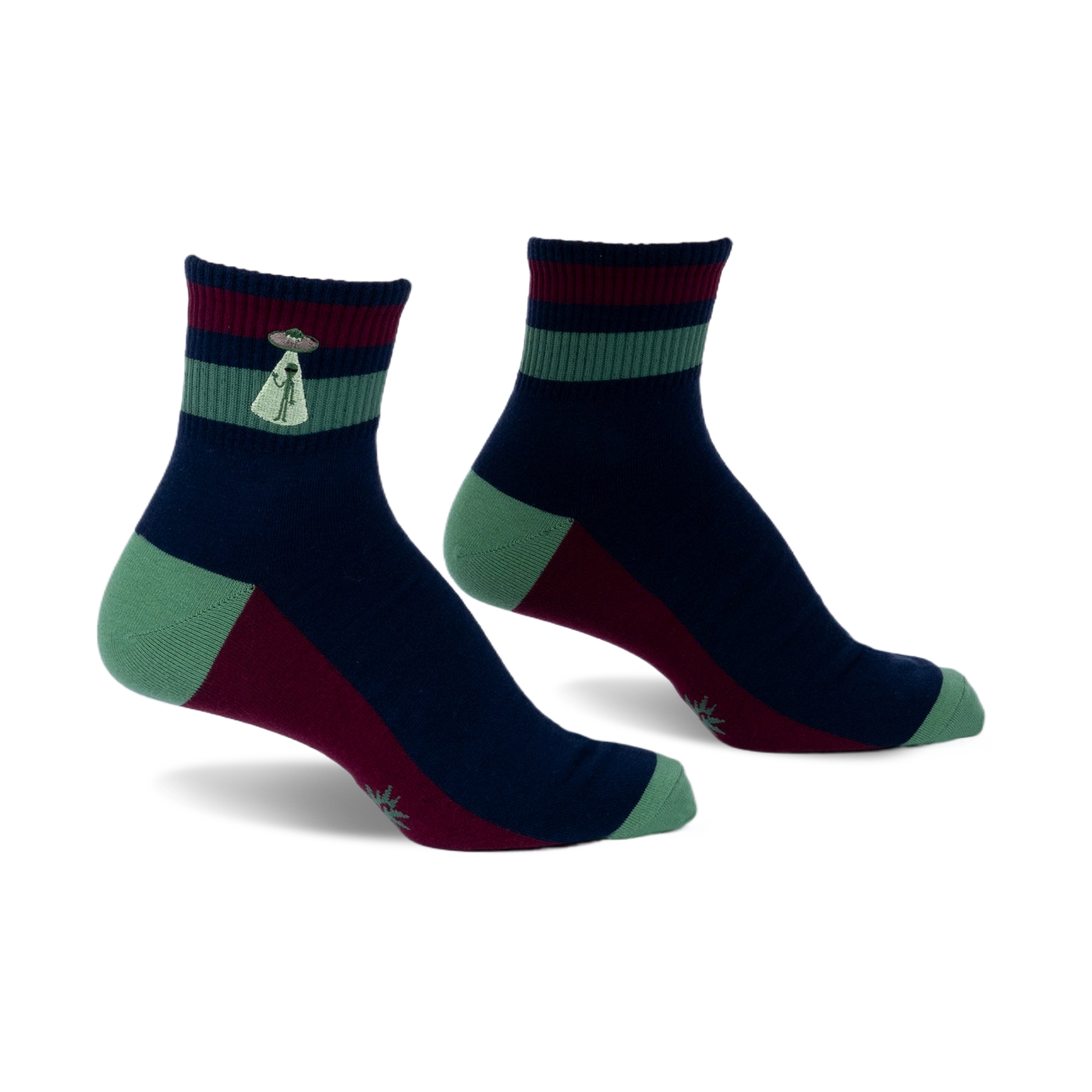 Pair of navy, burgundy, and green striped ankle socks. Features a small embroidered alien abduction scene on the cuff.