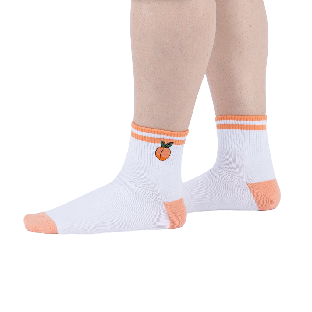 Lifestyle shot showing the socks on a person's feet against a white background.