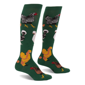 Pair of knee-high dark green socks featuring various types of chickens- mottled black, fluffy white, golden brown- with scattered eggs.