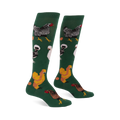 Pair of knee-high dark green socks featuring various types of chickens- mottled black, fluffy white, golden brown- with scattered eggs.