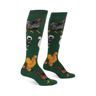 Pair of knee-high dark green socks featuring various types of chickens- mottled black, fluffy white, golden brown- with scattered eggs.