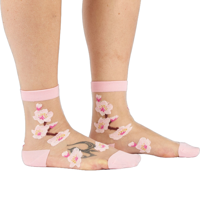 Sheer ankle socks with delicate embroidered pink cherry blossoms, pink cuffs, reinforced heels, and toes.