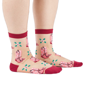 A person's legs and feet, wearing sheer pink cowboy boot socks from the side. Legs are bare against a white background.