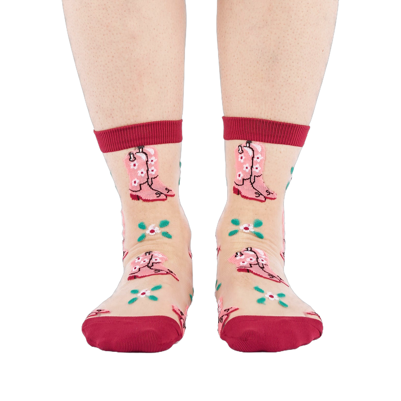 A person's legs and feet, wearing sheer pink cowboy boot socks, viewed from the front against a white background.