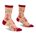 Pair of sheer ankle socks with pink cowboy boots and green clover flowers on a light beige background, with dark red cuffs, heels, and toes.