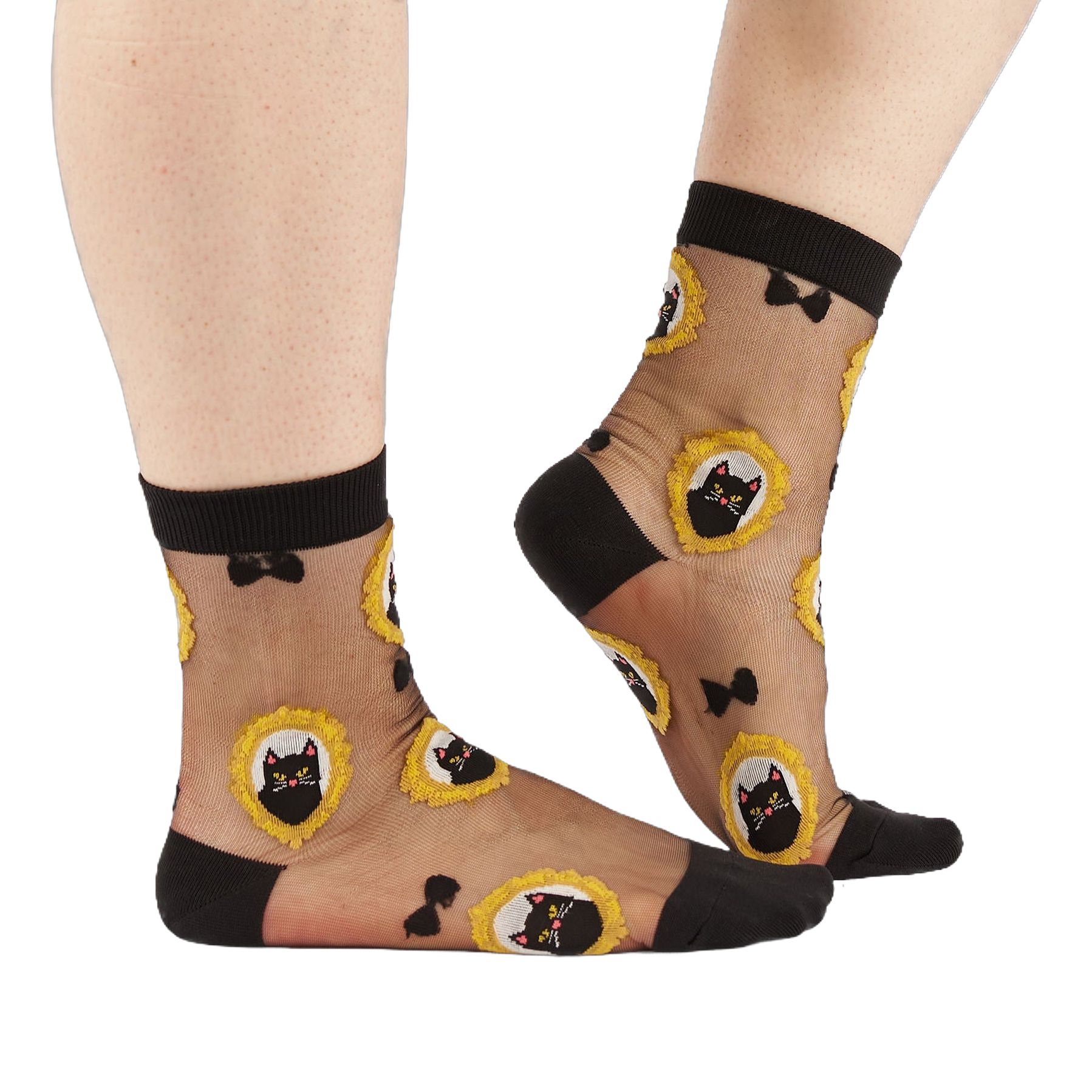 Person's lower legs and feet wearing the sheer black cat socks, standing on a white background.
