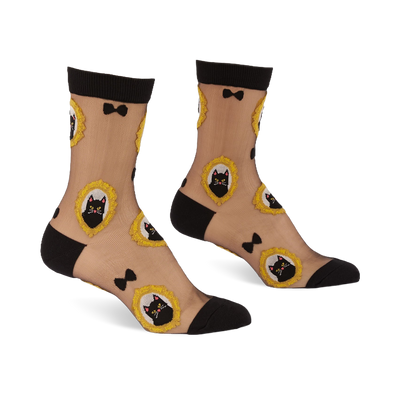 Sheer ankle socks with black cuffs, heels, and toes. Feature black cat faces in frilly gold frames and small black bows.