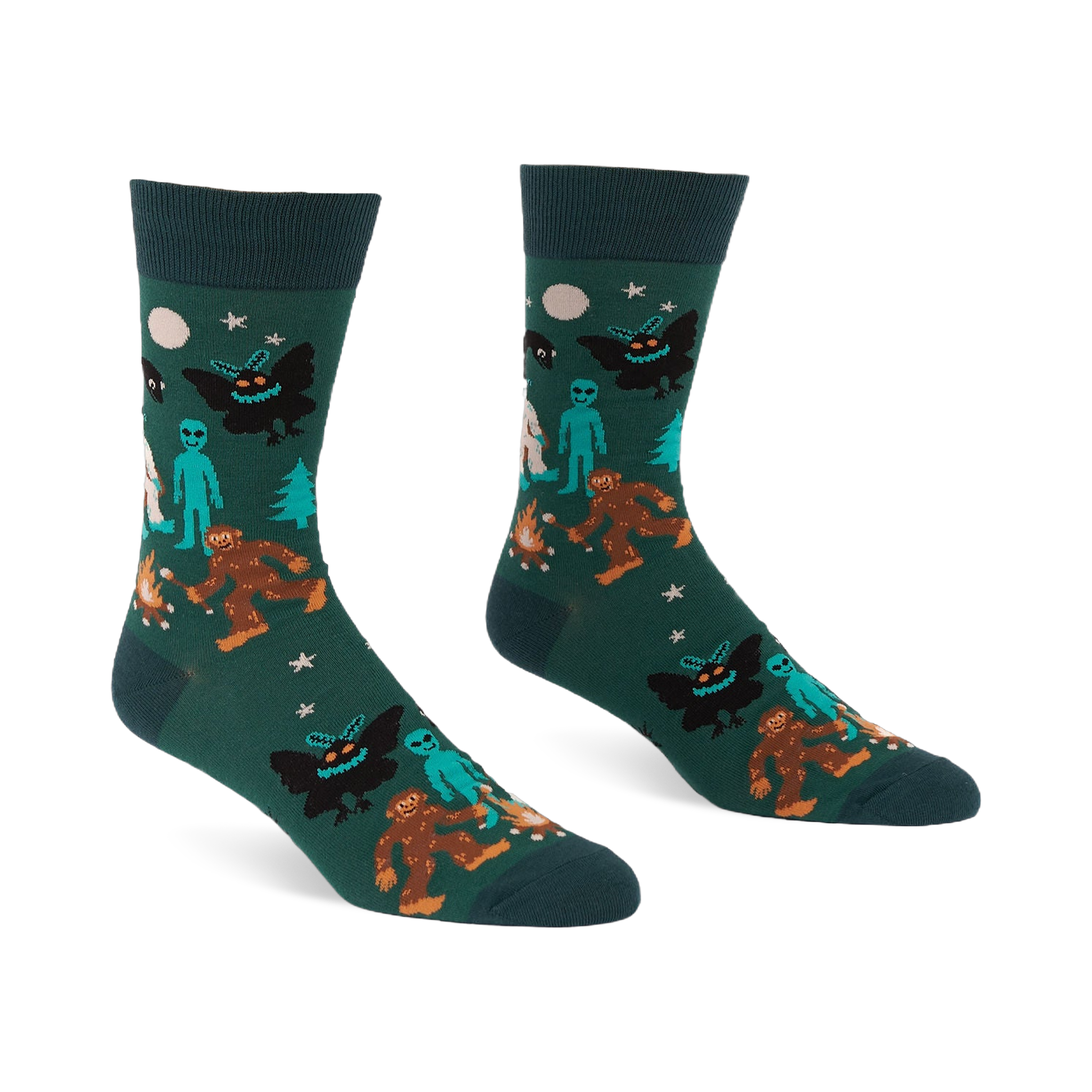 Pair of dark green crew socks with a repeating pattern of Bigfoot, Mothman, alien, Yeti, campfire, trees, moon, and stars.