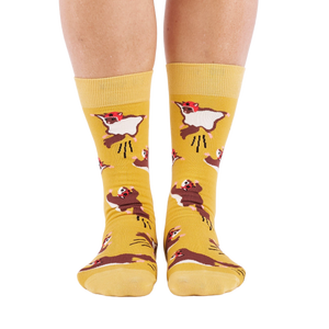 Person standing, wearing mustard yellow crew socks with flying squirrel pattern, viewed from the front.