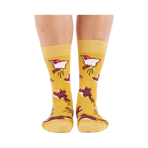 Person standing, wearing mustard yellow crew socks with flying squirrel pattern, viewed from the front.