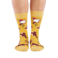 Person standing, wearing mustard yellow crew socks with flying squirrel pattern, viewed from the front.